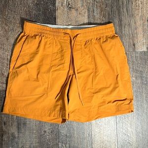 These are Lululemon shorts. The color is a burnt orange size large in men.